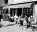 Venice, Italy - April 11, 2015: People sat outside the street cafe, Bar Stelling on a warm spring day  in Venice. There are groups sat at tables and also a pushchair at the end of one of the tables. In the foreground is a woman smoking.